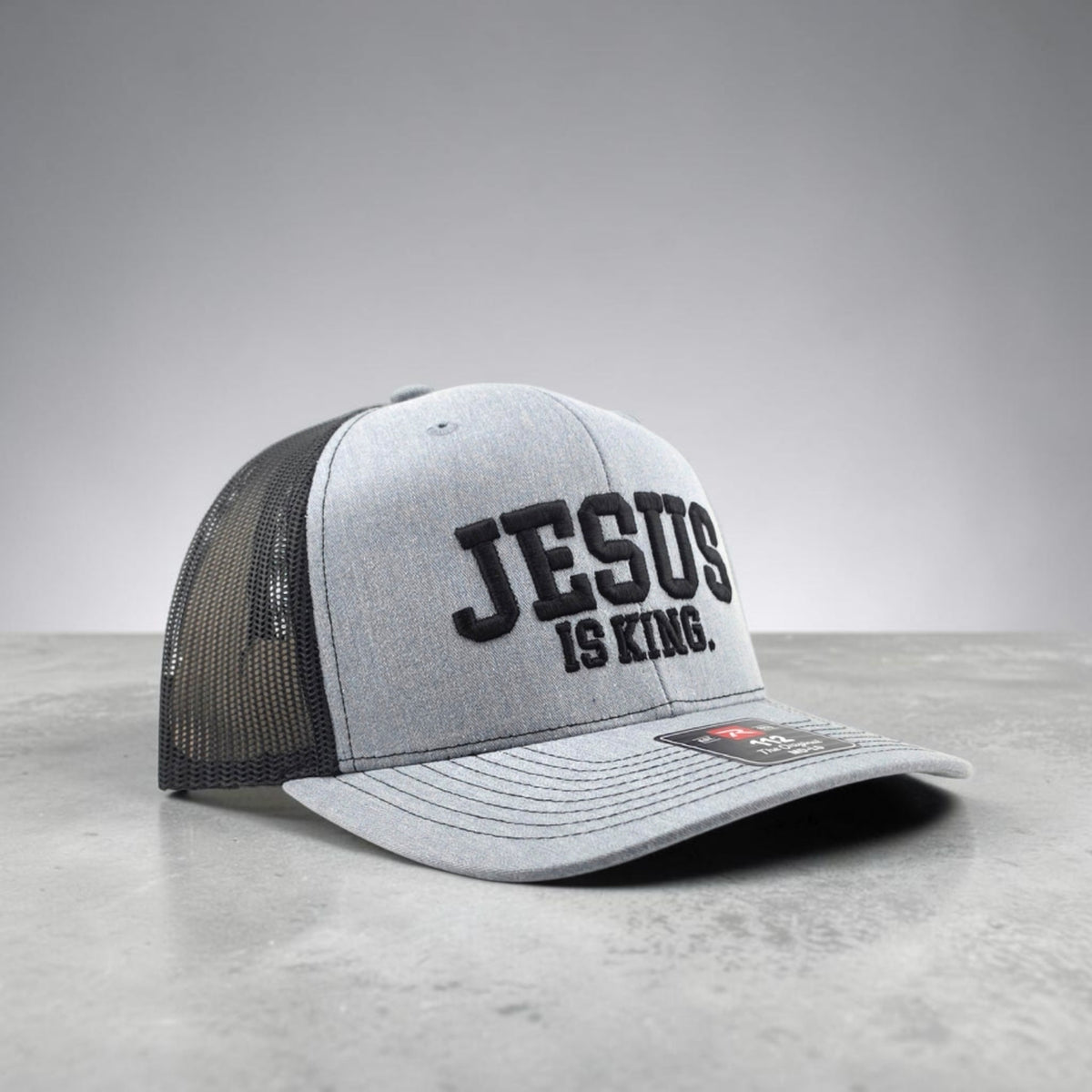 Jesus Is King Christian hat, 3D puff embroidered Richardson 112 trucker hat - right side angle with black mesh back