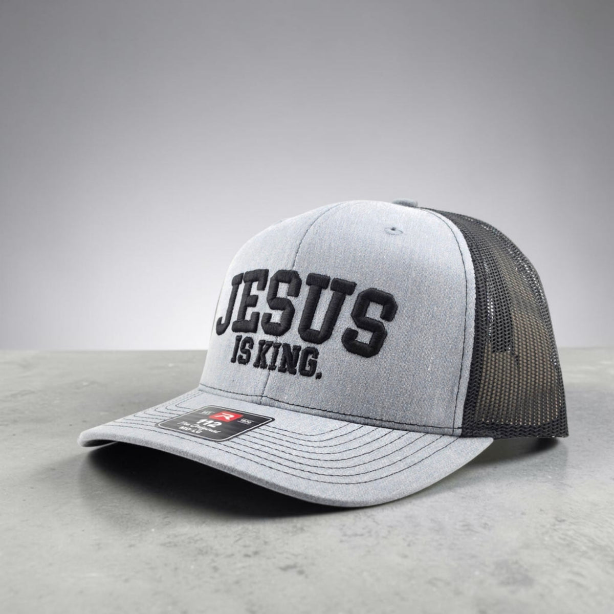 Jesus Is King Christian hat, 3D puff embroidered Richardson 112 trucker hat - left side angle with black mesh back